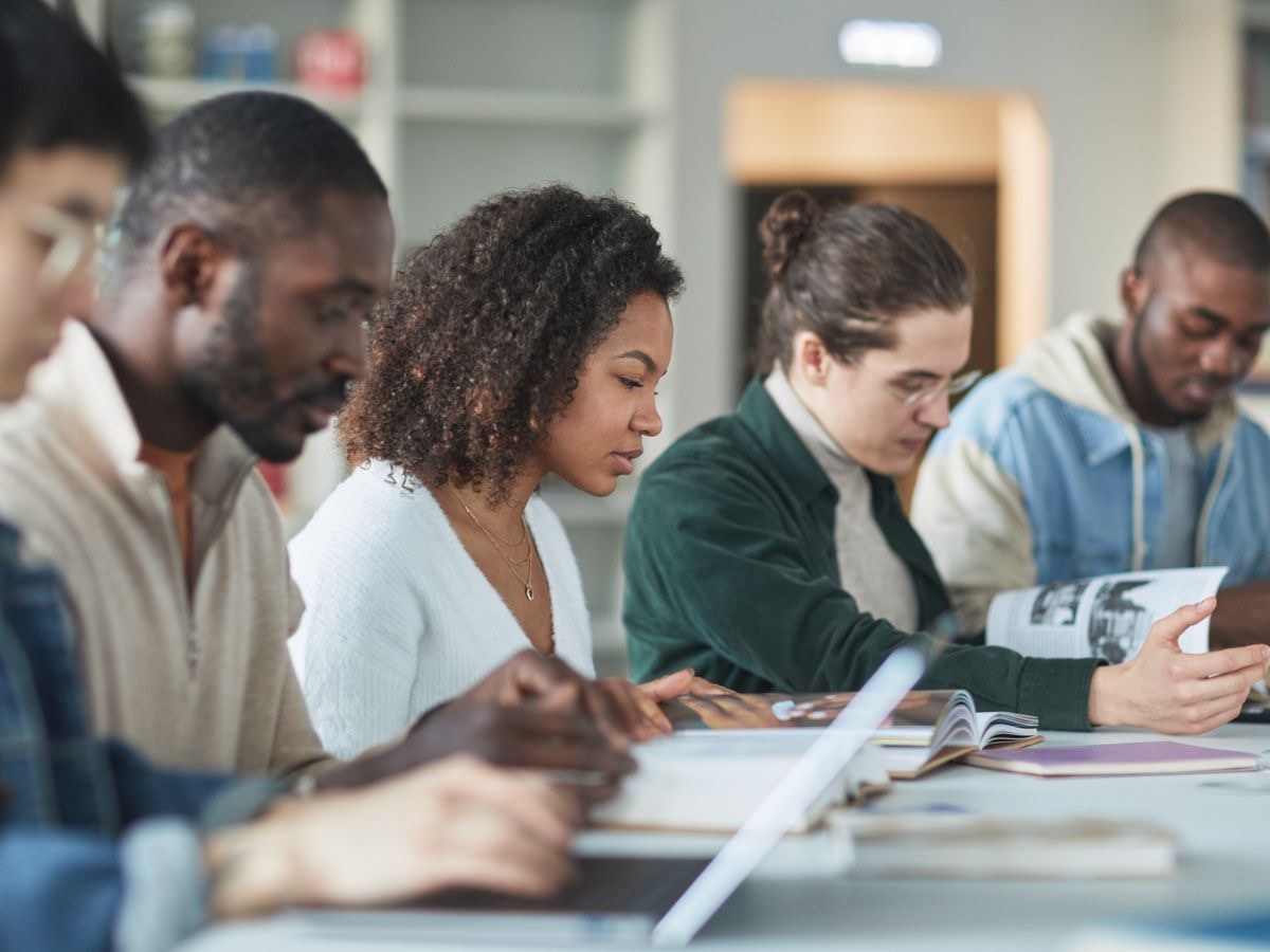 A diverse group of students studying together in a bright library — the academic ambition ResolveIt exists to serve.