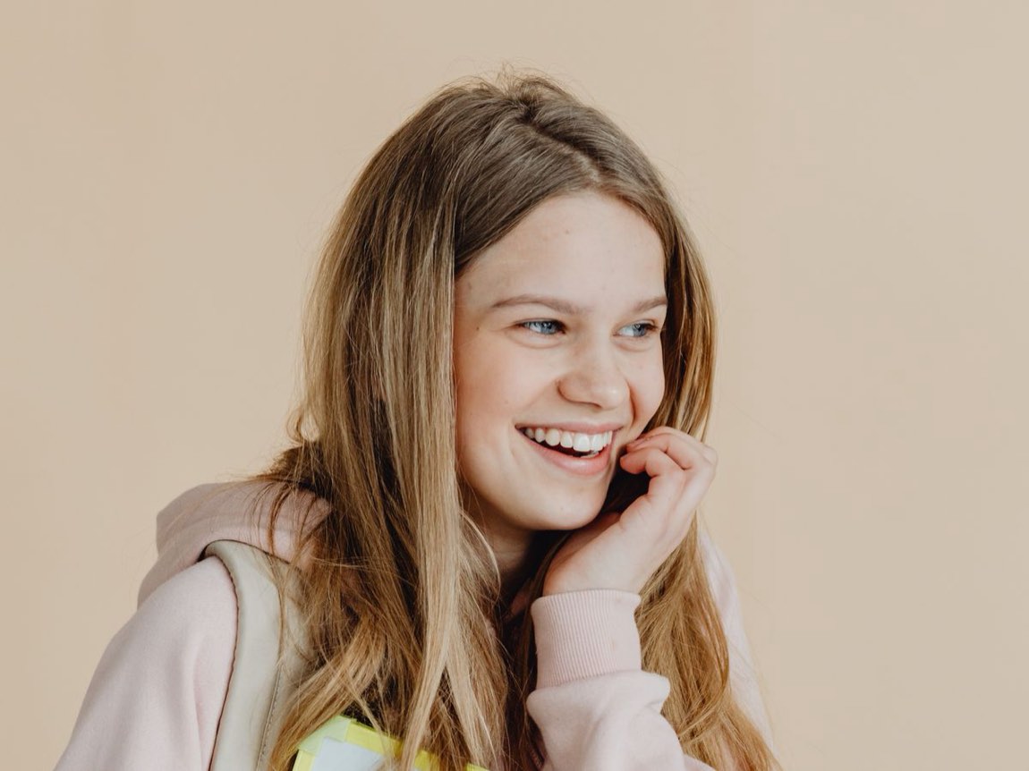 A student smiling with genuine confidence — the self-belief that grows once Maths finally clicks.