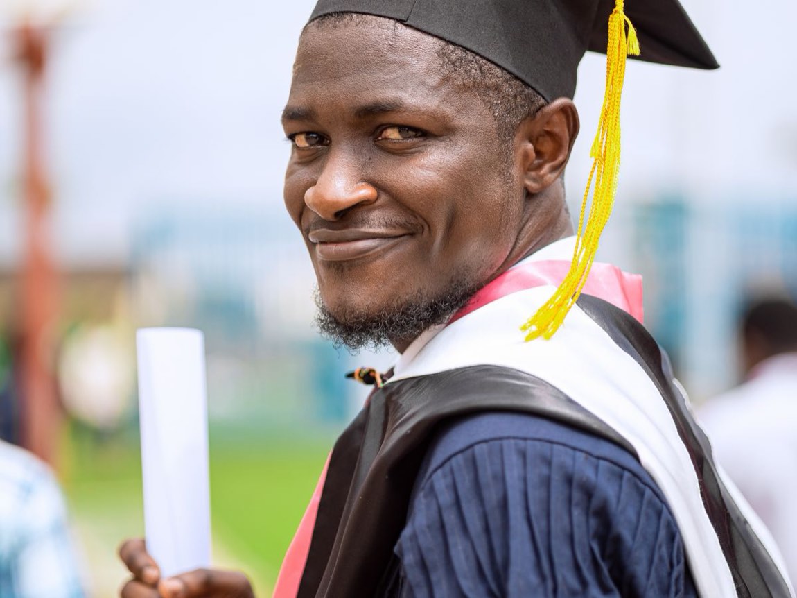 A proud graduate holding their diploma — the university future a strong A* makes possible.