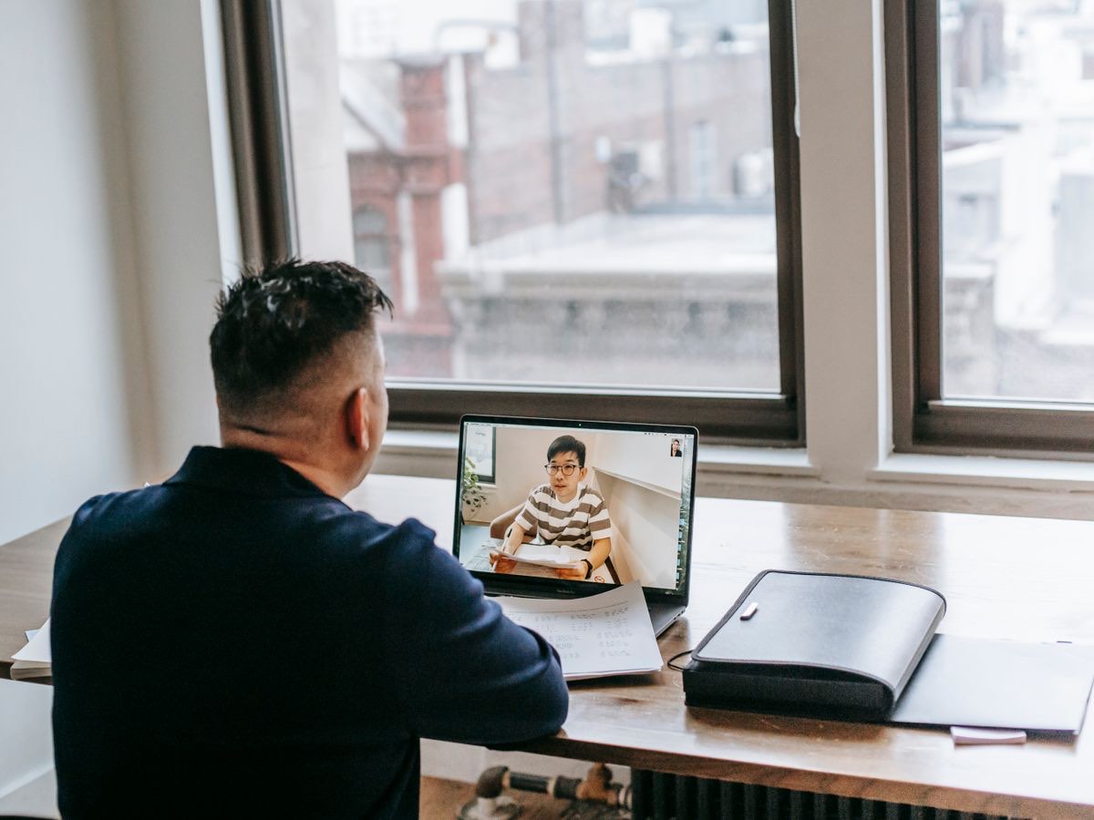 A ResolveIt-style online lesson in progress — a tutor working one-to-one with a student over video, working notes to hand.